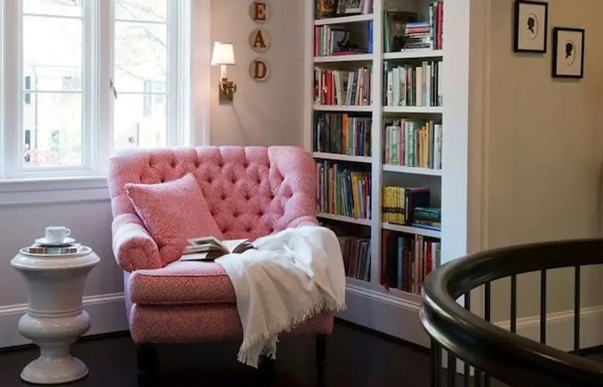 A cozy reading nook with a comfortable chair and soft blanket.