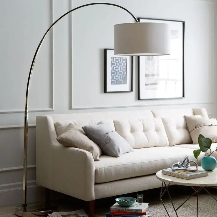 A stylish floor lamp next to a comfortable armchair.