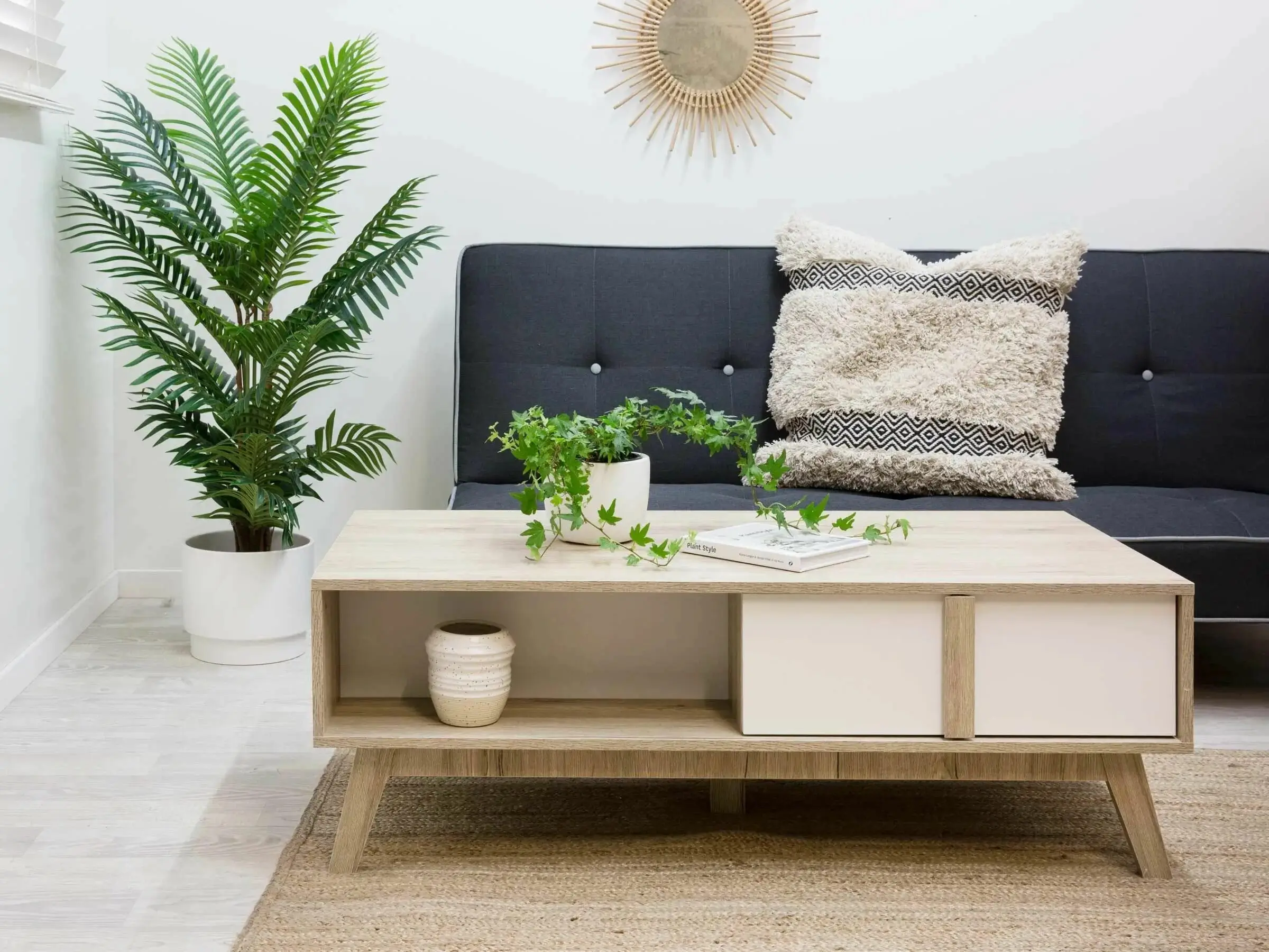A minimalist wooden side table with a plant.