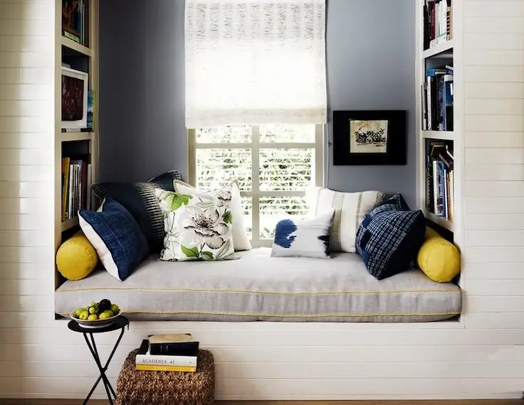 A cozy reading nook with a comfortable chair and soft blanket.