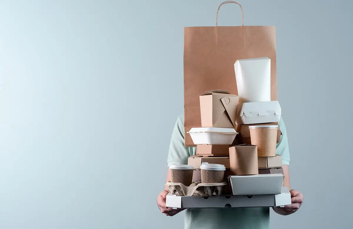 A person carefully wrapping a product in sustainable packaging.