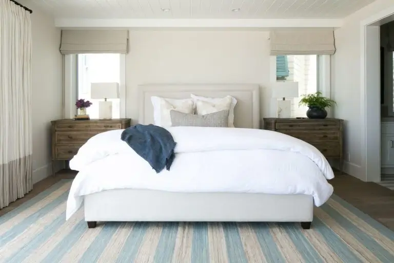 A peaceful bedroom with natural light and soft bedding.